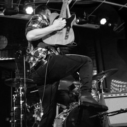 Darren rocking out to Bruce Springsteen's iconic song 'Born in the USA' during a tribute band performance.